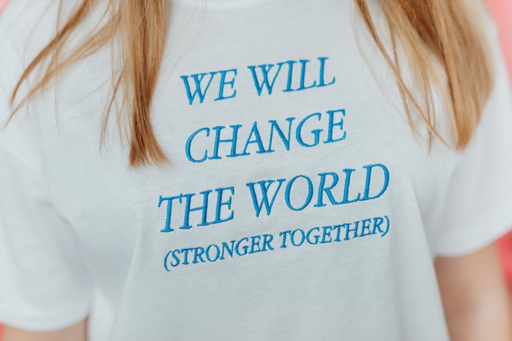 Woman in White T-Shirt with Blue Text